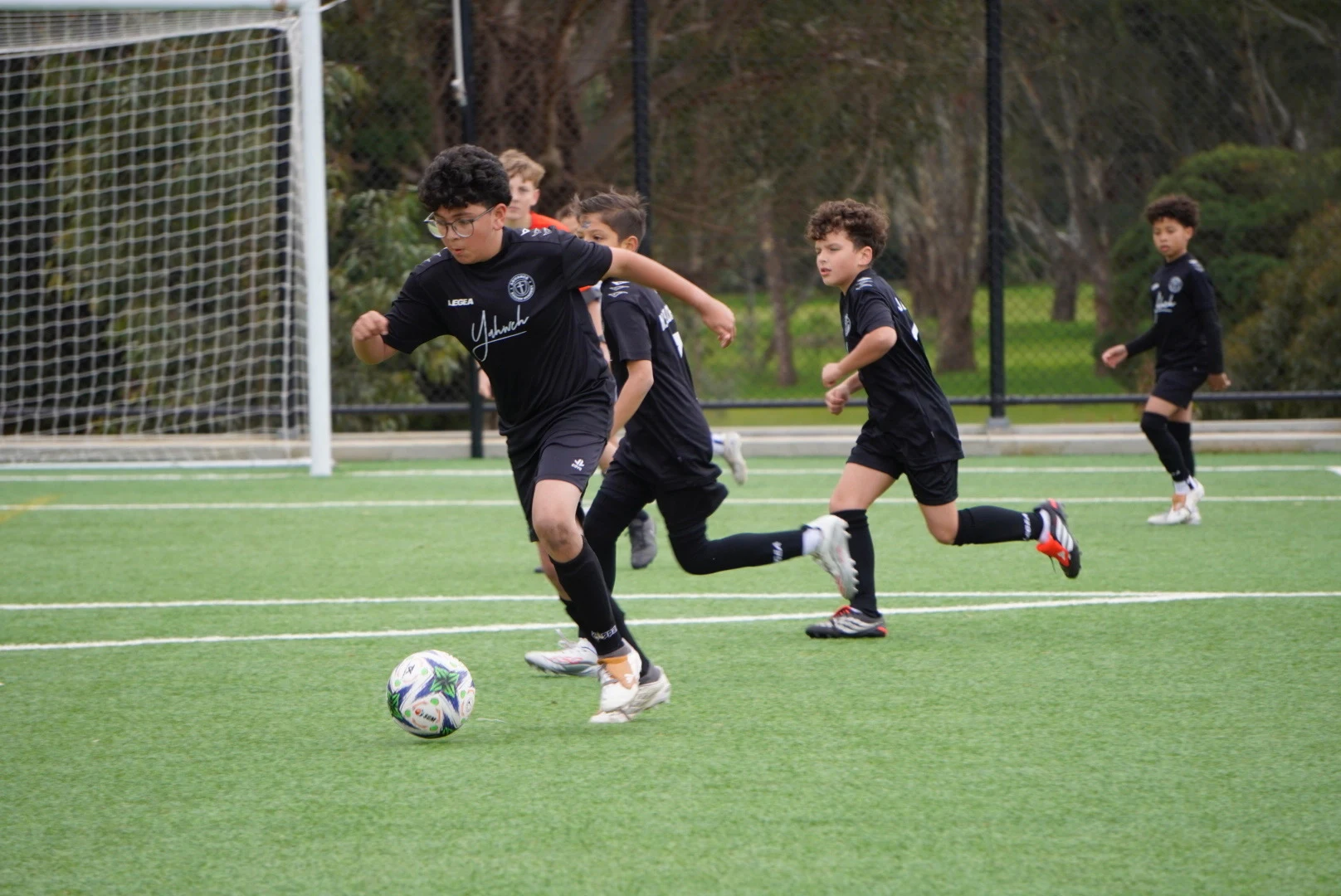 Advance Football players practising their skills against opponents